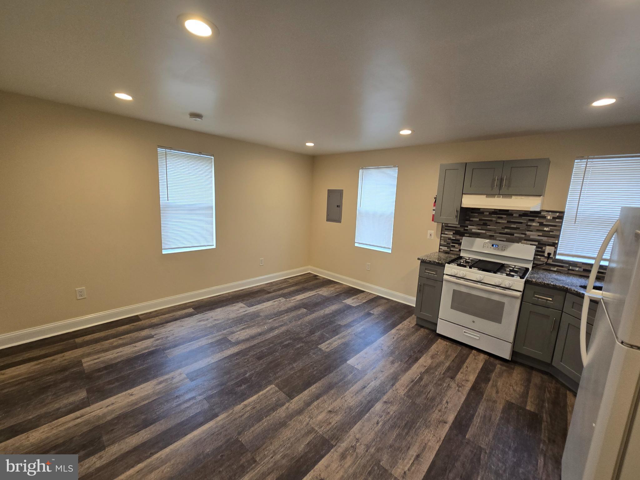 915 MacDade Boulevard Collingdale, PA 19023 - Photo 4 of 15 a kitchen with granite countertop a stove and a refrigerator