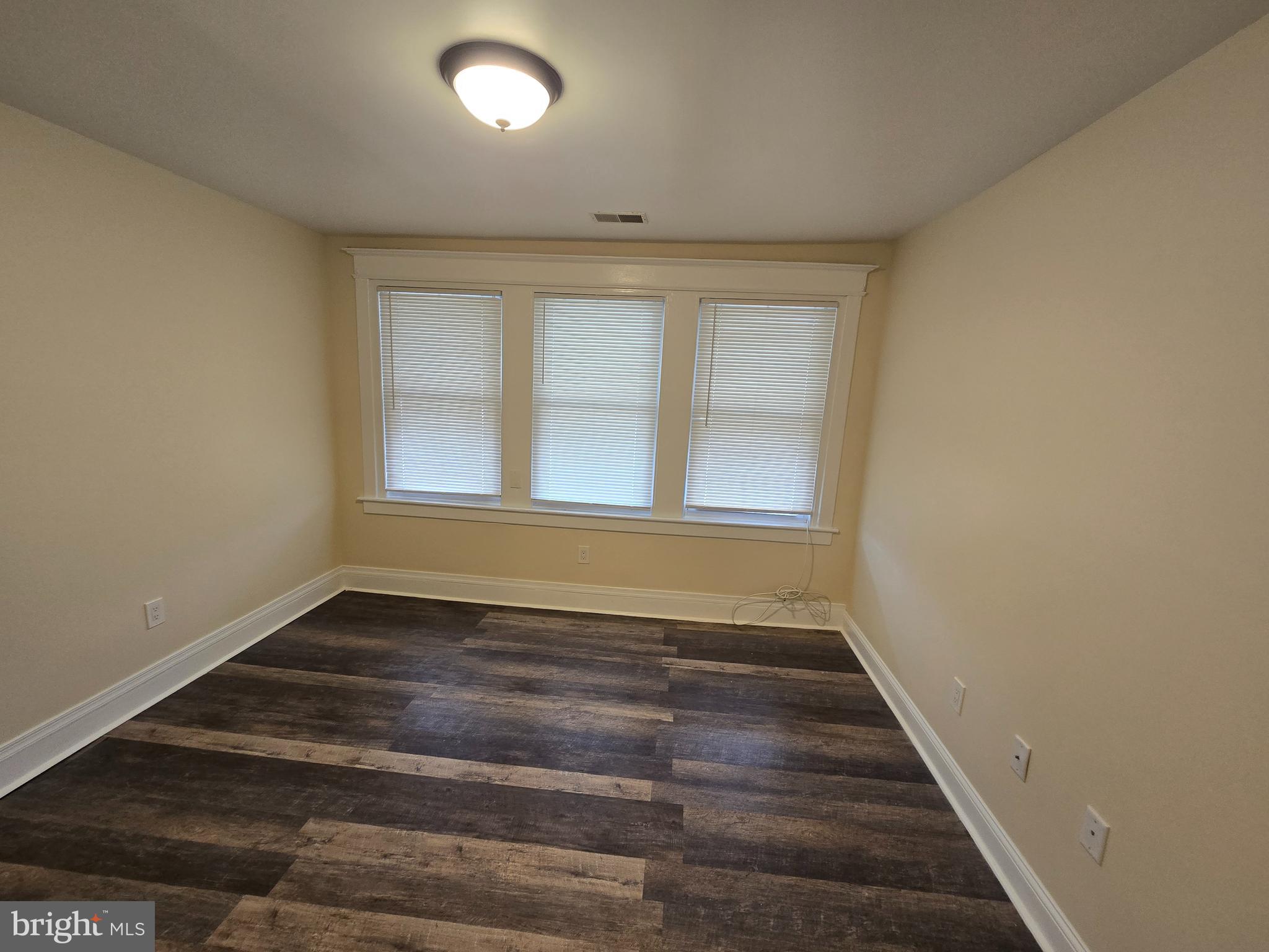 915 MacDade Boulevard Collingdale, PA 19023 - Photo 8 of 15 a view of an empty room with wooden floor and a window