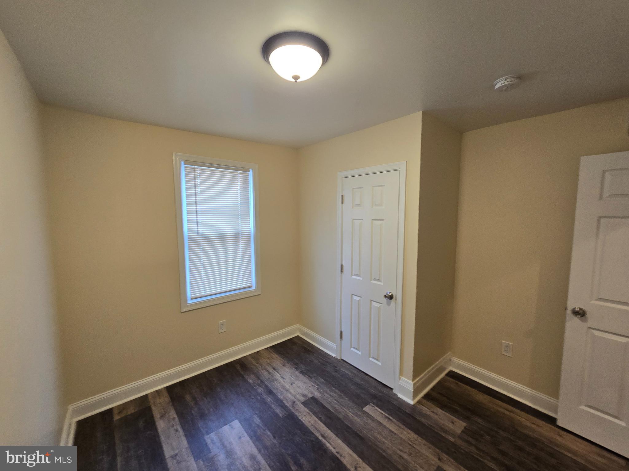 915 MacDade Boulevard Collingdale, PA 19023 - Photo 10 of 15 a view of an empty room with wooden floor and a window