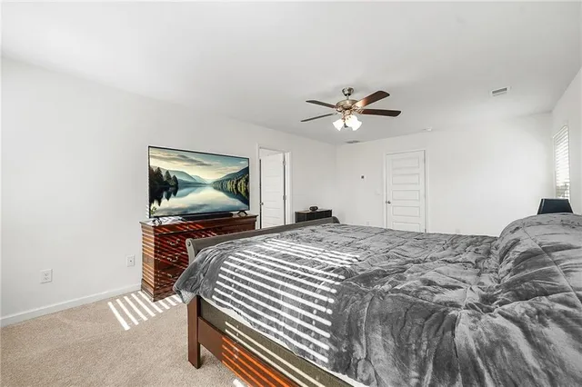 a bedroom with bed and a chandelier