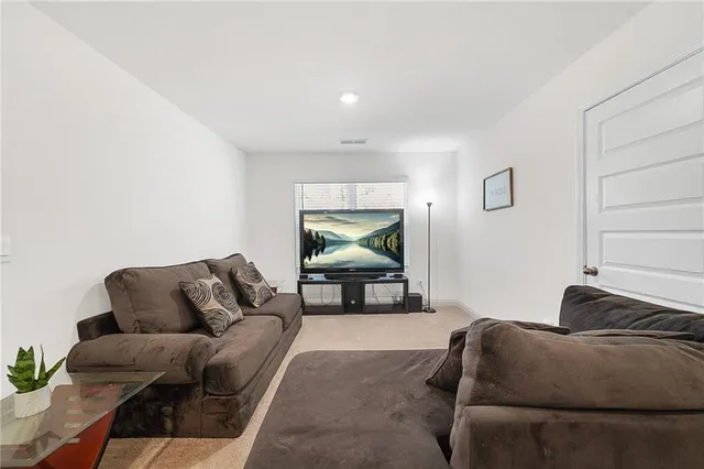 a living room with furniture and a lamp