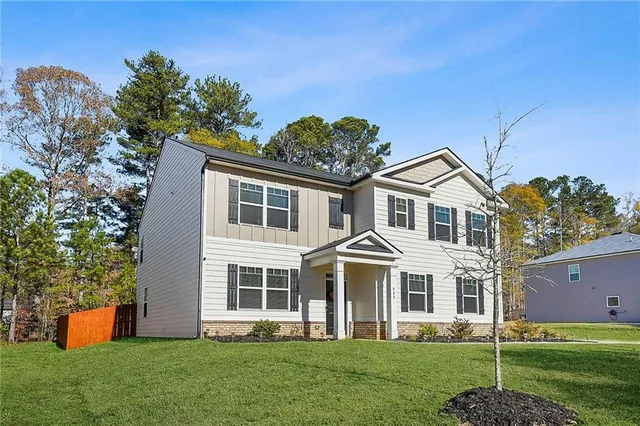 a front view of a house with a yard