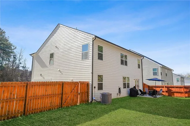 a view of house with backyard
