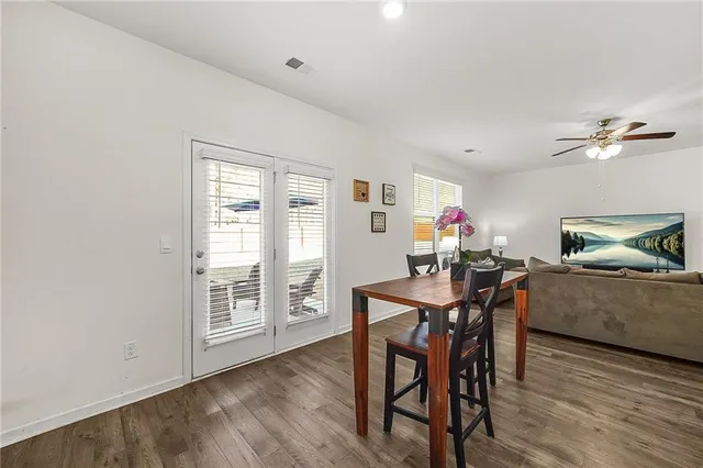 a view of a dining room with furniture and a window