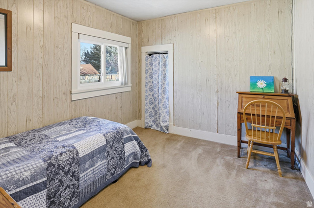 380 North 200 West Logan, UT 84321 - Photo 12 of 29 Bedroom with light colored carpet and wooden walls