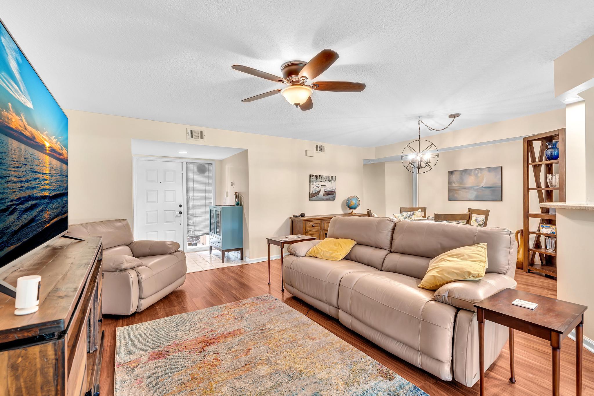 17372 Boca Club Boulevard, Unit 405 Boca Raton, FL 33487 - Photo 25 of 74 a living room with furniture a ceiling fan and a flat screen tv
