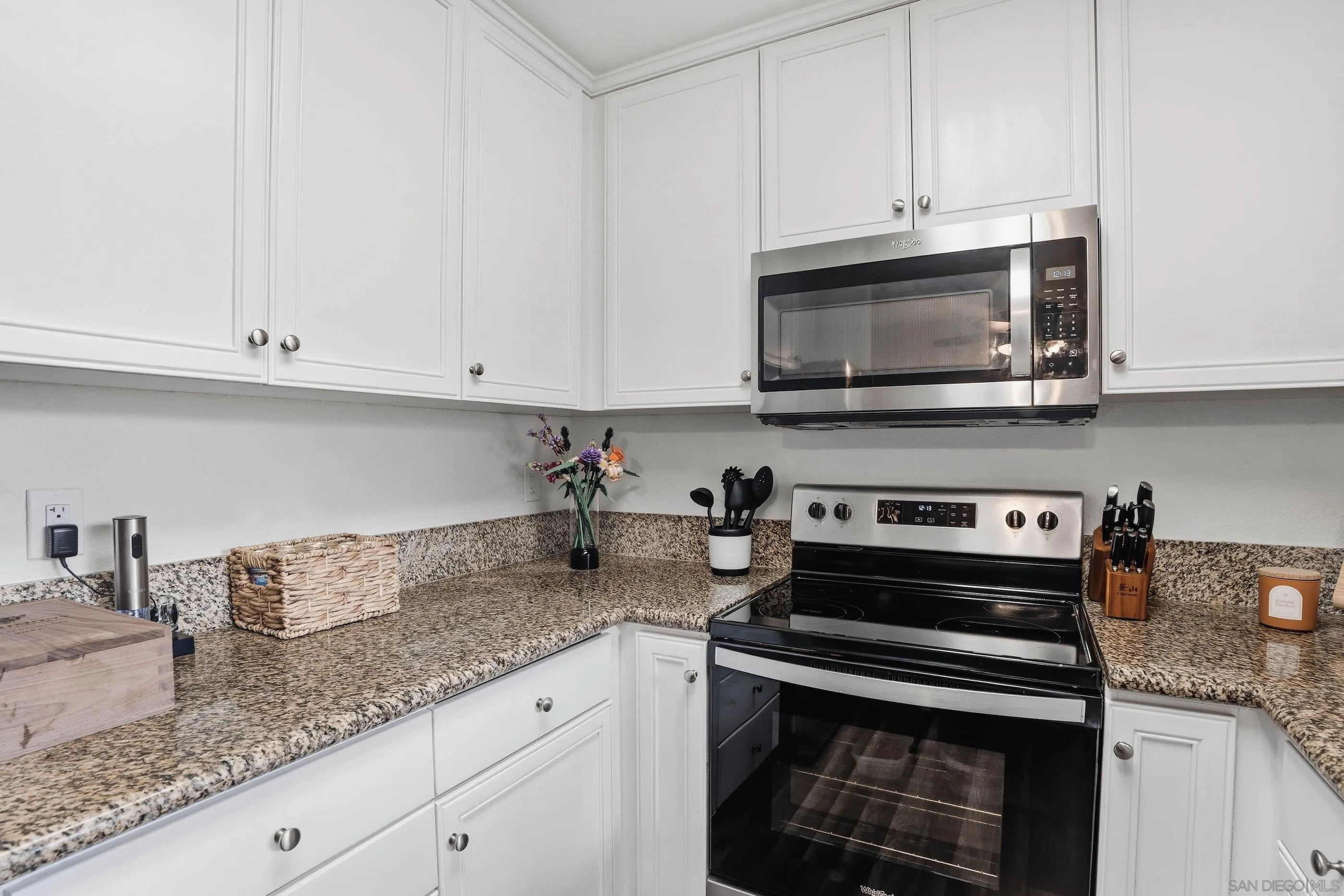 1423 Graves Avenue, Unit 240 El Cajon, CA 92021 - Photo 13 of 25 a kitchen with granite countertop white cabinets and a stove top oven