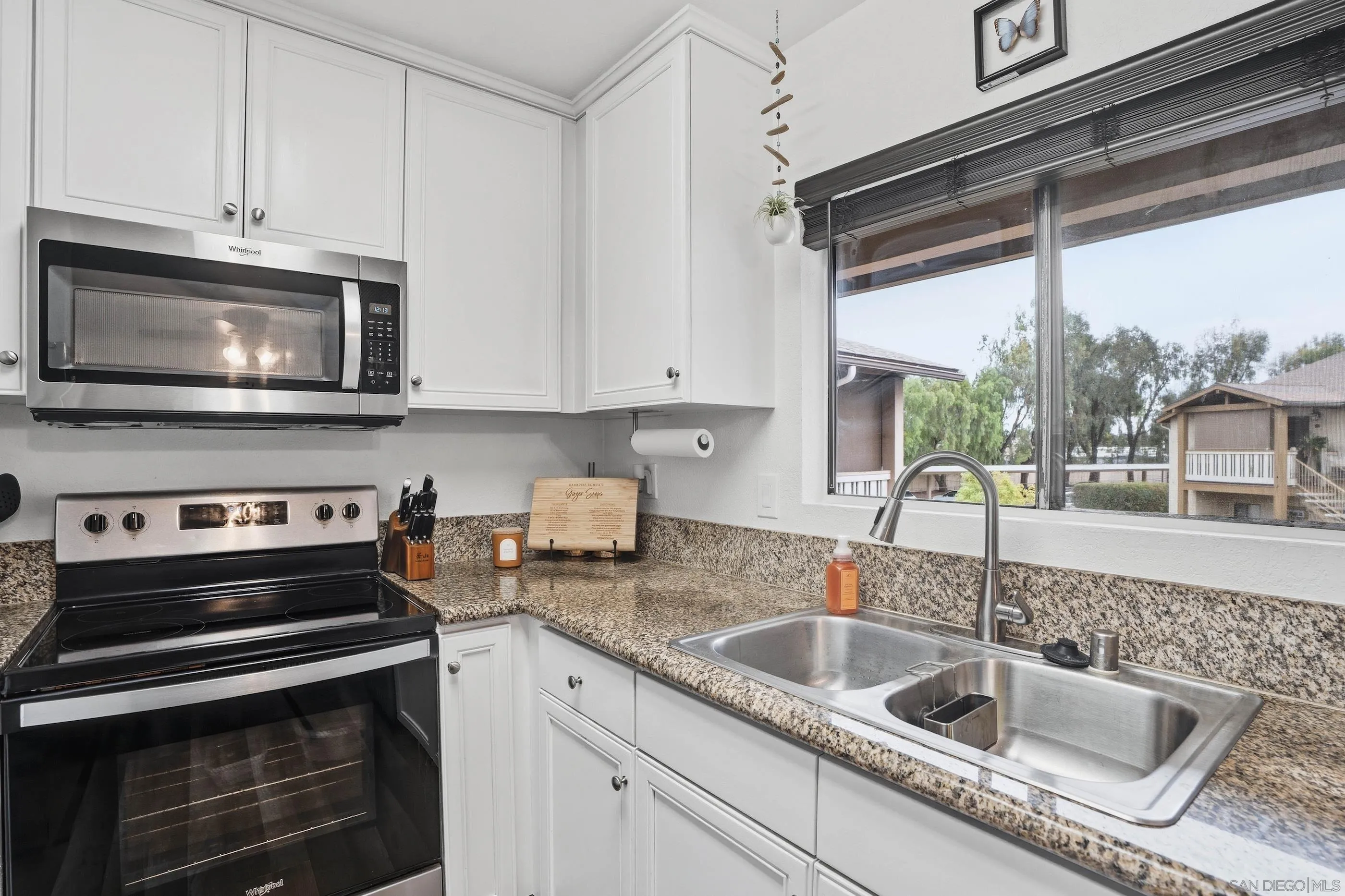 1423 Graves Avenue, Unit 240 El Cajon, CA 92021 - Photo 15 of 25 a kitchen with stainless steel appliances granite countertop a sink stove and microwave