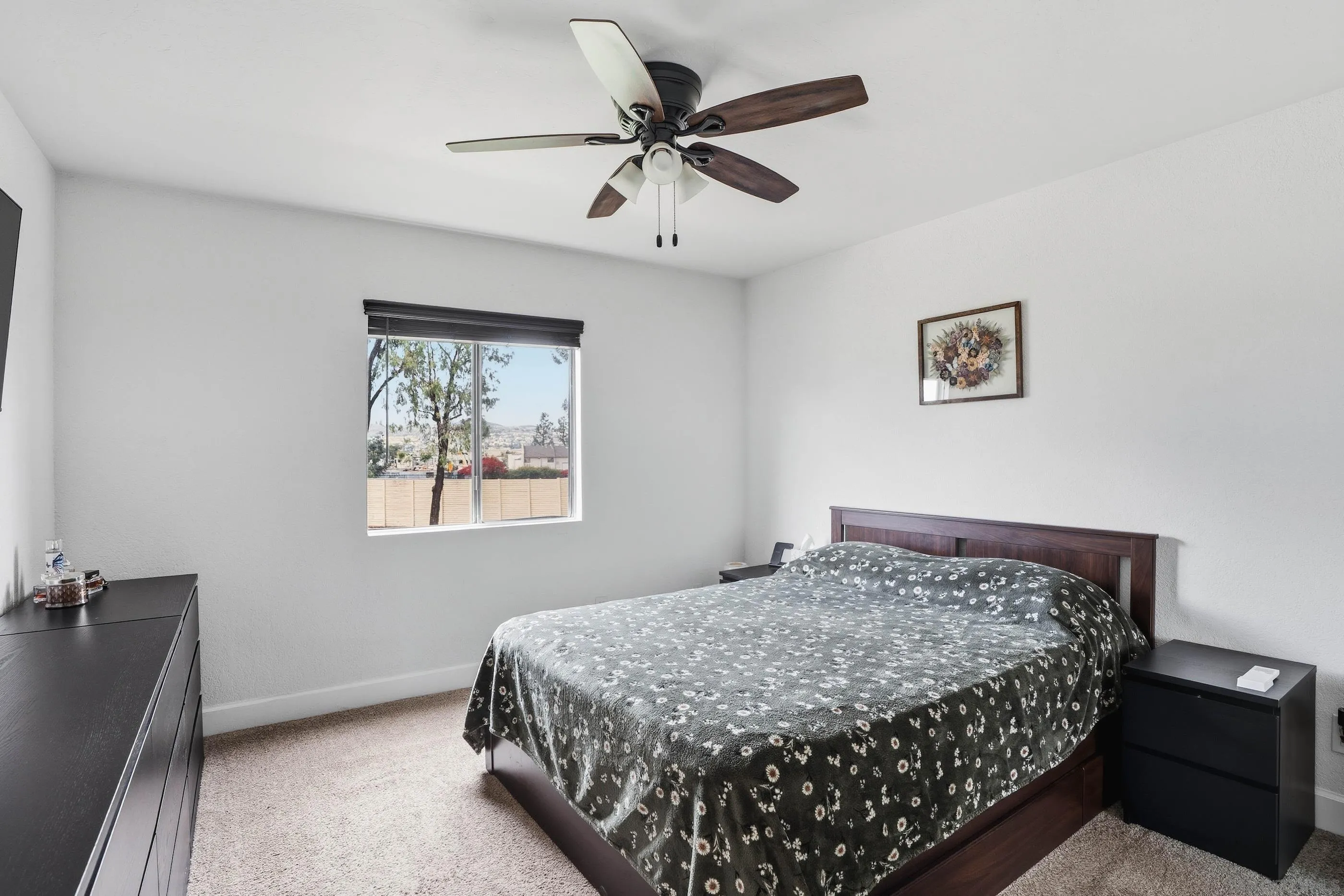 1423 Graves Avenue, Unit 240 El Cajon, CA 92021 - Photo 20 of 25 a bedroom with a bed and a painting on the wall