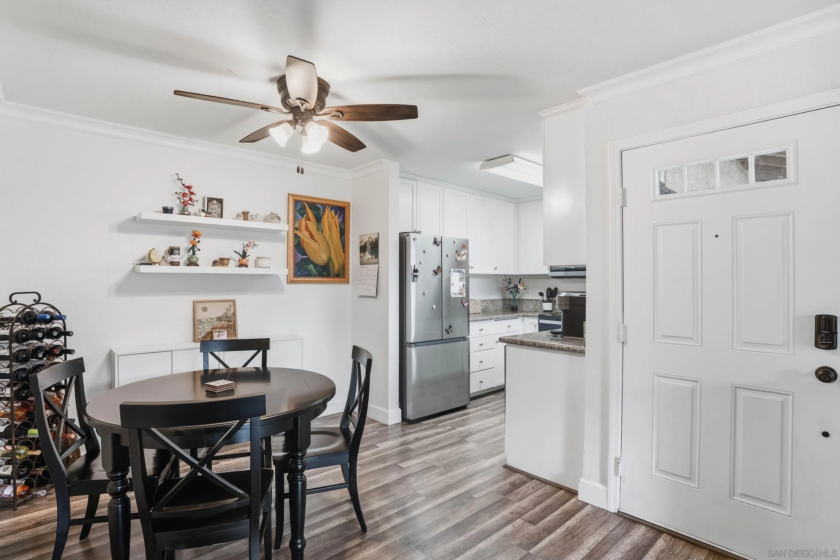 1423 Graves Avenue, Unit 240 El Cajon, CA 92021 - Photo 10 of 25 a kitchen with stainless steel appliances a dining table chairs refrigerator and cabinets