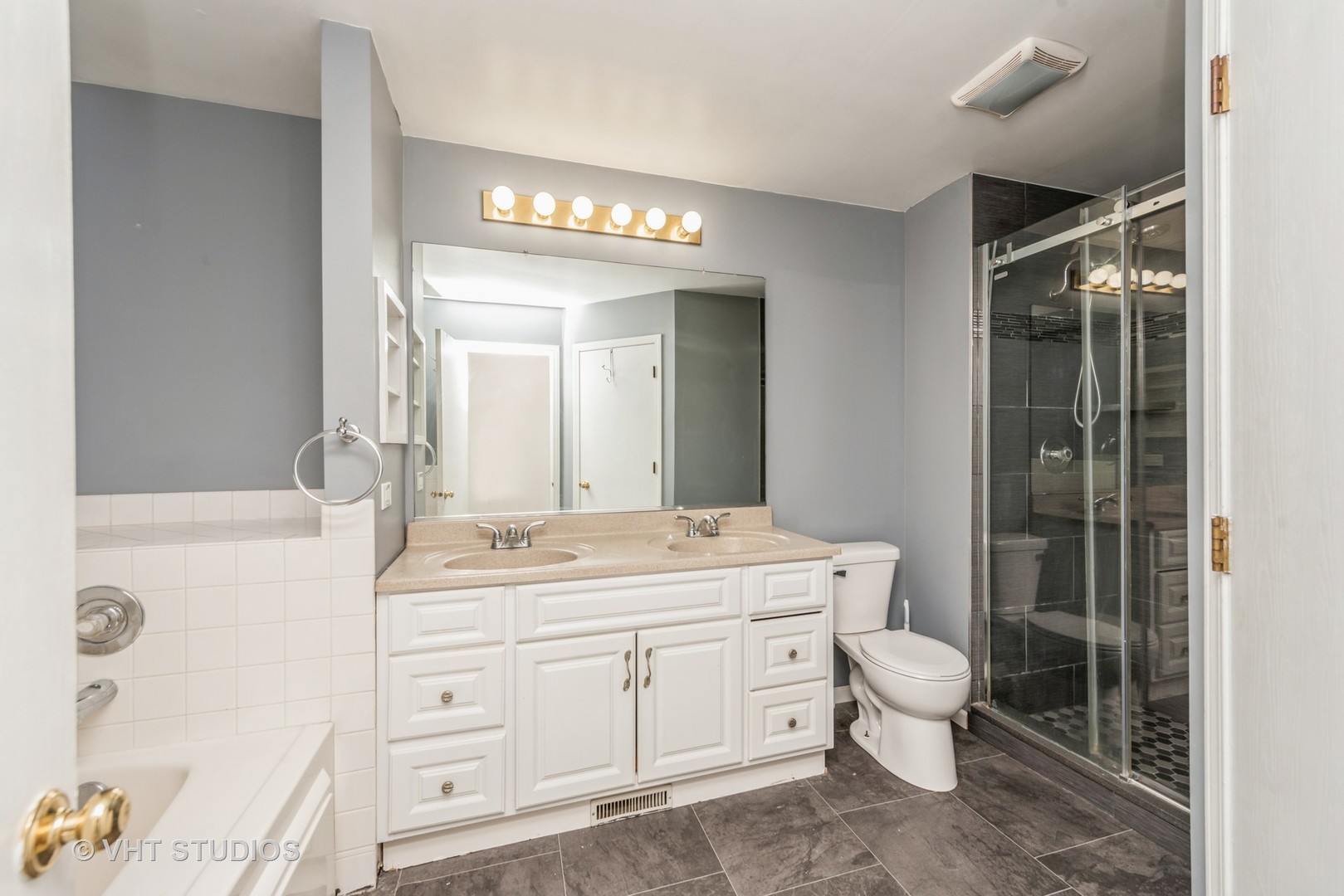 125 Parkview Drive Wauconda, IL 60084 - Photo 9 of 14 a spacious bathroom with a double vanity sink a toilet a mirror and shower