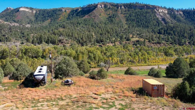 a view of a field with a mountain in the background
