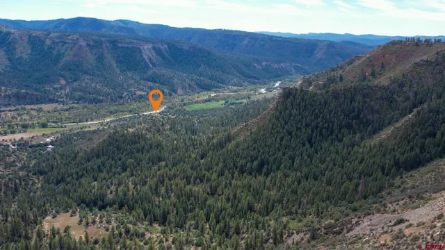 a view of a yard with wooden fence
