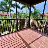 a view of a balcony with wooden floor