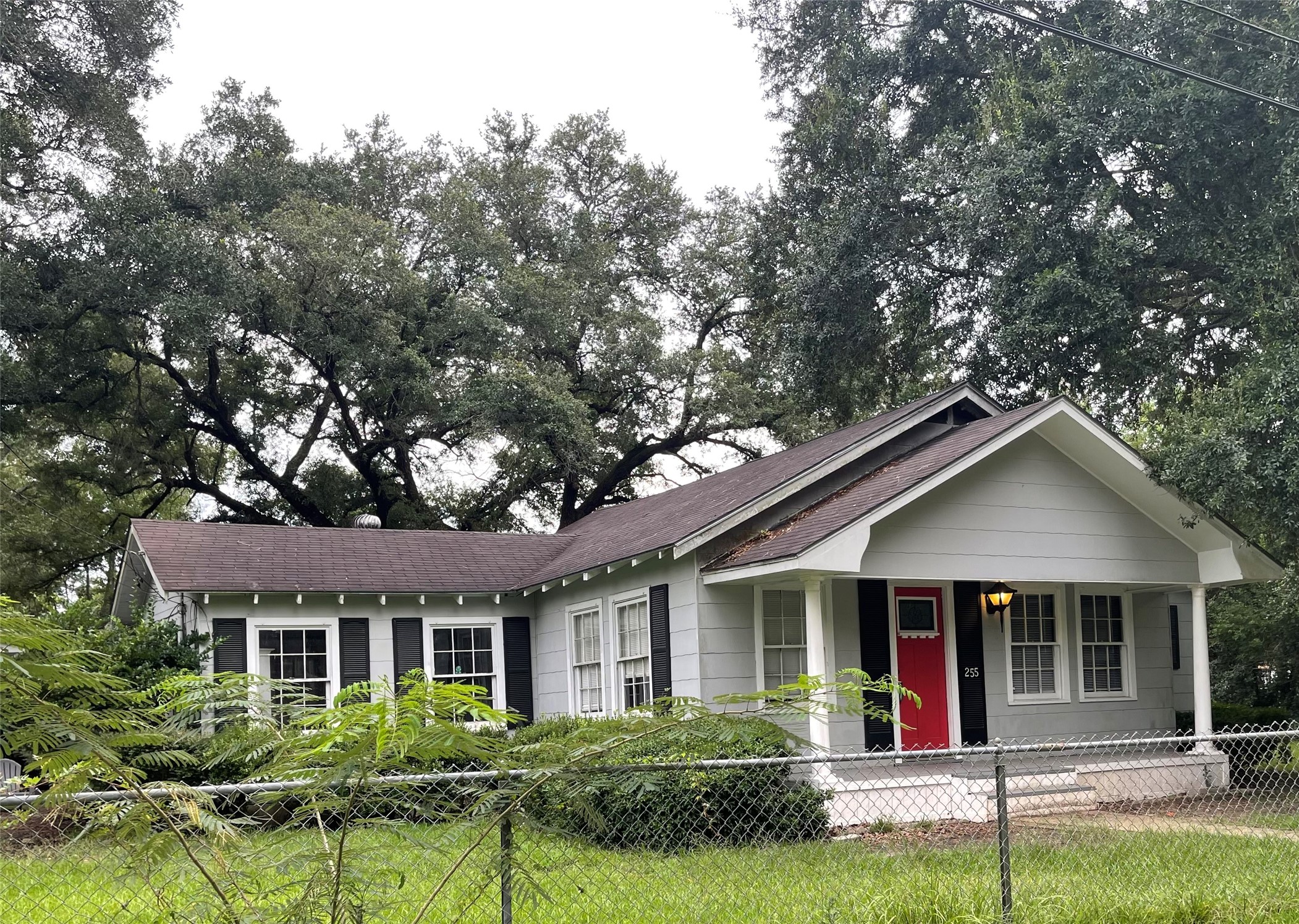 255 Frank Street, Unit AB Kountze, TX 77625 - Photo 1 of 33 a front view of a house with a yard and potted plants