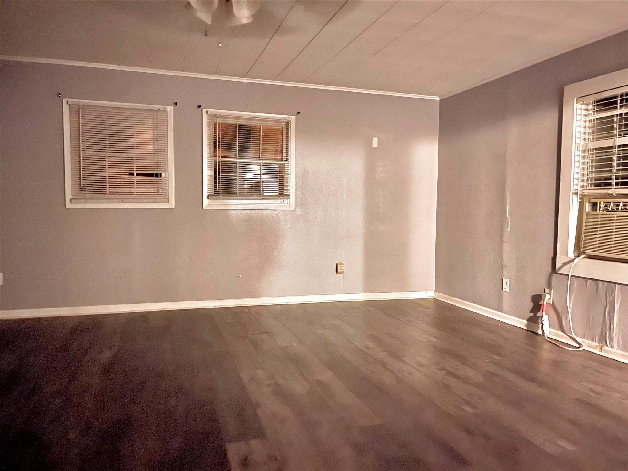 255 Frank Street, Unit AB Kountze, TX 77625 - Photo 13 of 33 a view of an empty room with wooden floor and a window