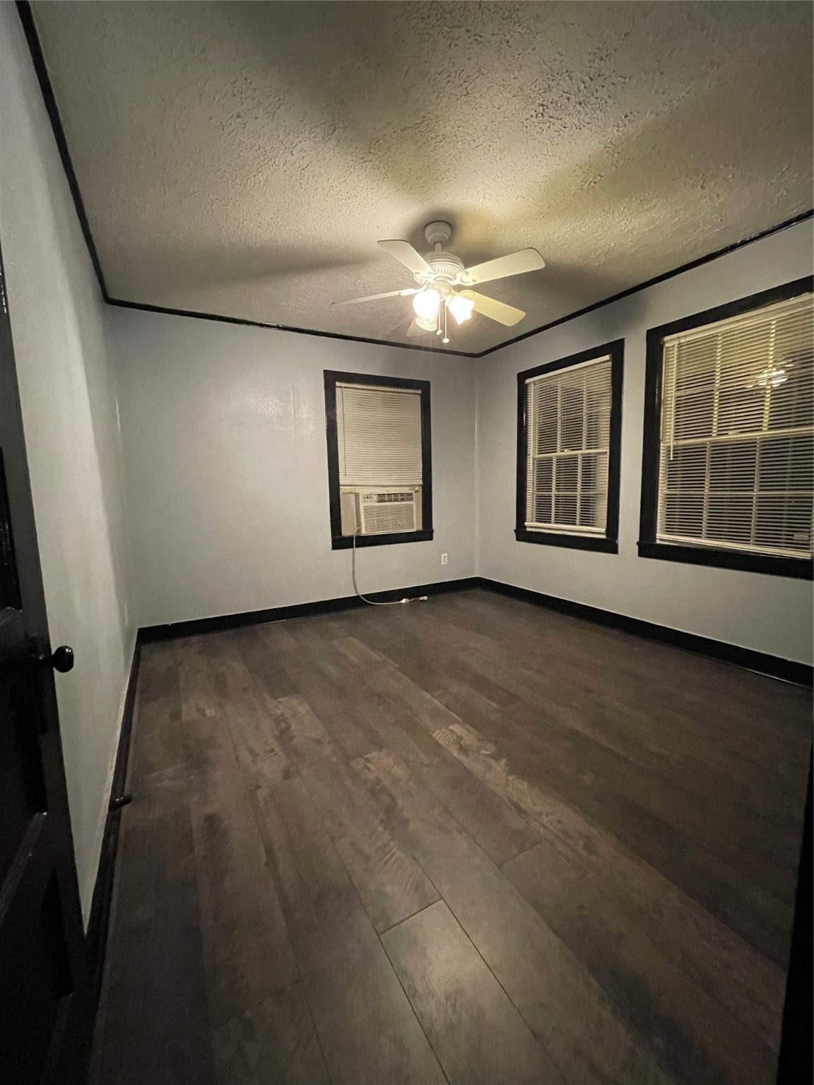 255 Frank Street, Unit AB Kountze, TX 77625 - Photo 2 of 33 an empty room with wooden floor and windows