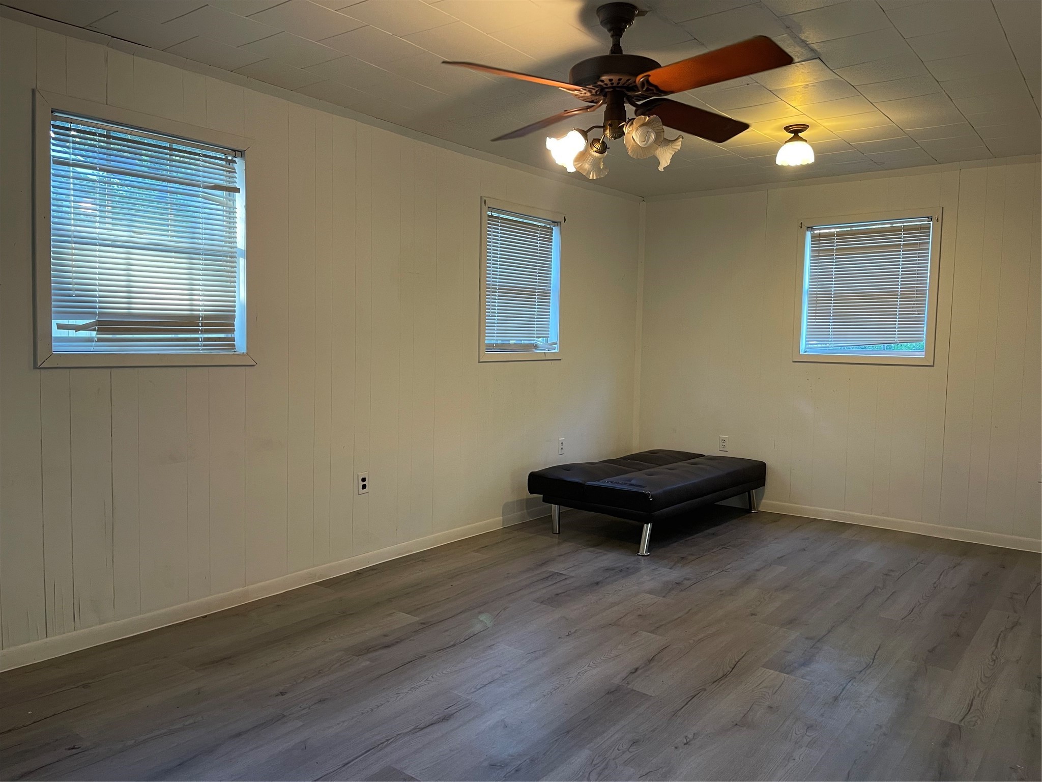 255 Frank Street, Unit AB Kountze, TX 77625 - Photo 29 of 33 a view of a room with wooden floor and a ceiling fan