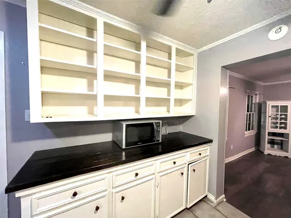 a kitchen with granite countertop cabinets and window