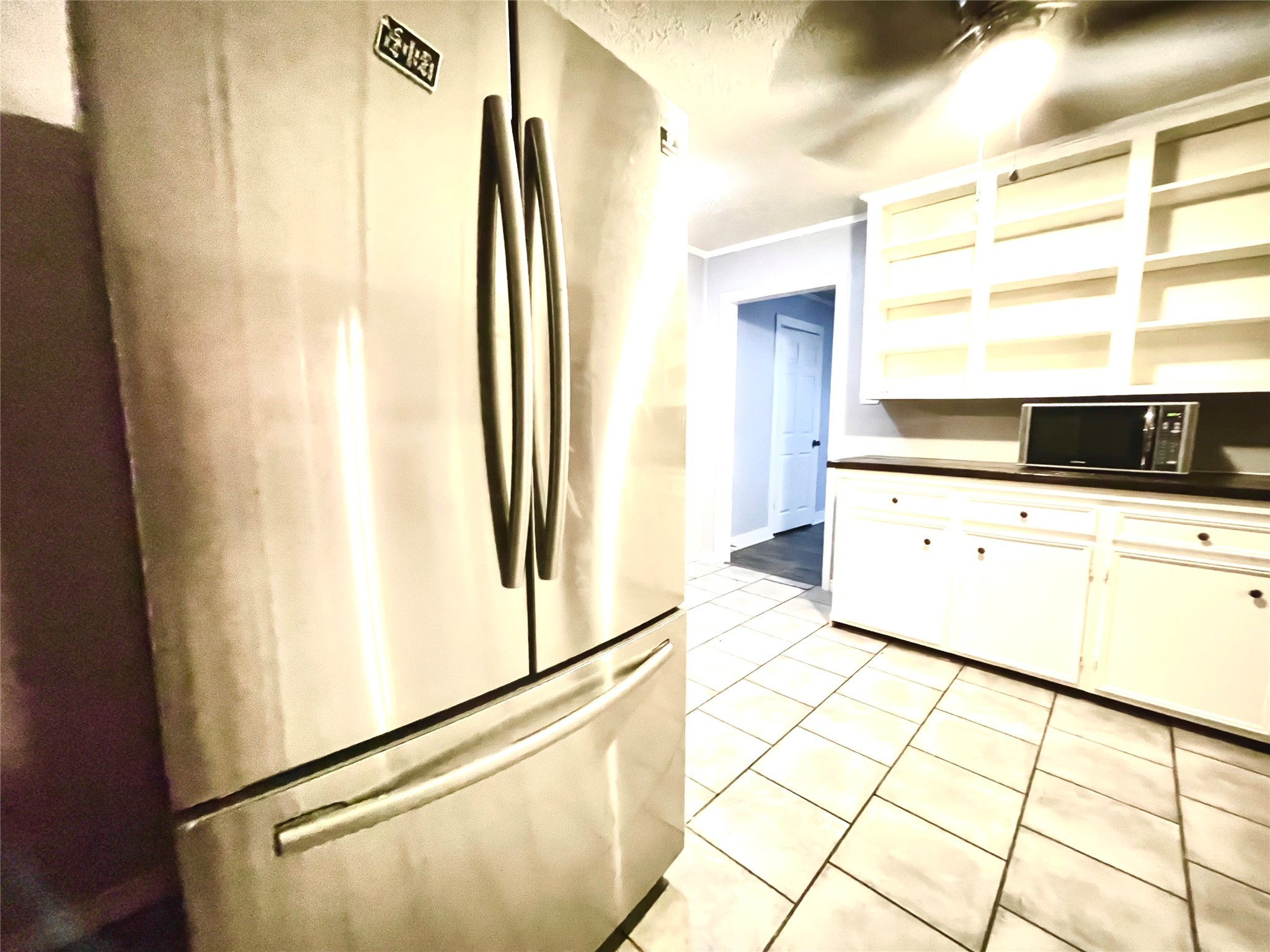 255 Frank Street, Unit AB Kountze, TX 77625 - Photo 5 of 33 a kitchen with stainless steel appliances a refrigerator sink and cabinets