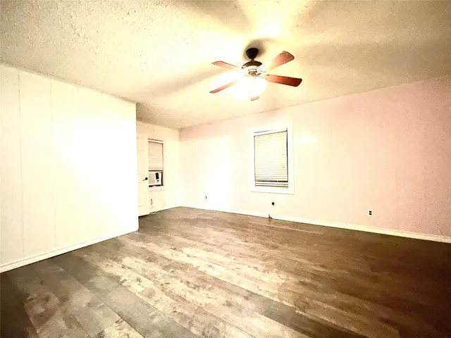 a view of a room with wooden floor and bathroom