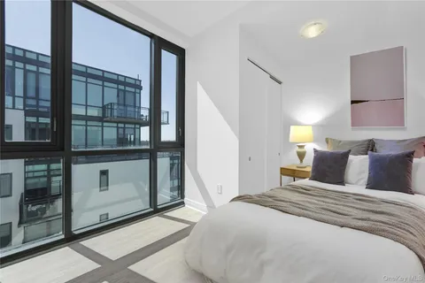 a bedroom with a large bed and a window