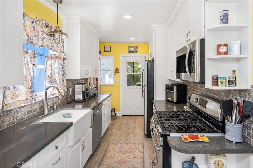 358 North Shaffer Street Orange, CA 92866 - Photo 27 of 45 a kitchen with stainless steel appliances granite countertop a sink stove and refrigerator