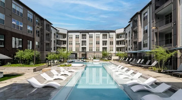 a view of a house with swimming pool and sitting area