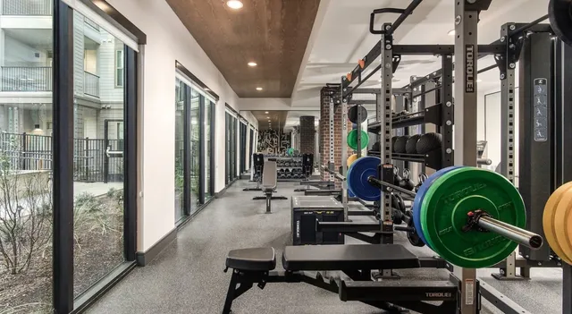 a view of a workspace with furniture and floor to ceiling window