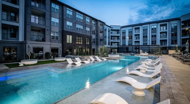 a swimming pool with outdoor seating and yard