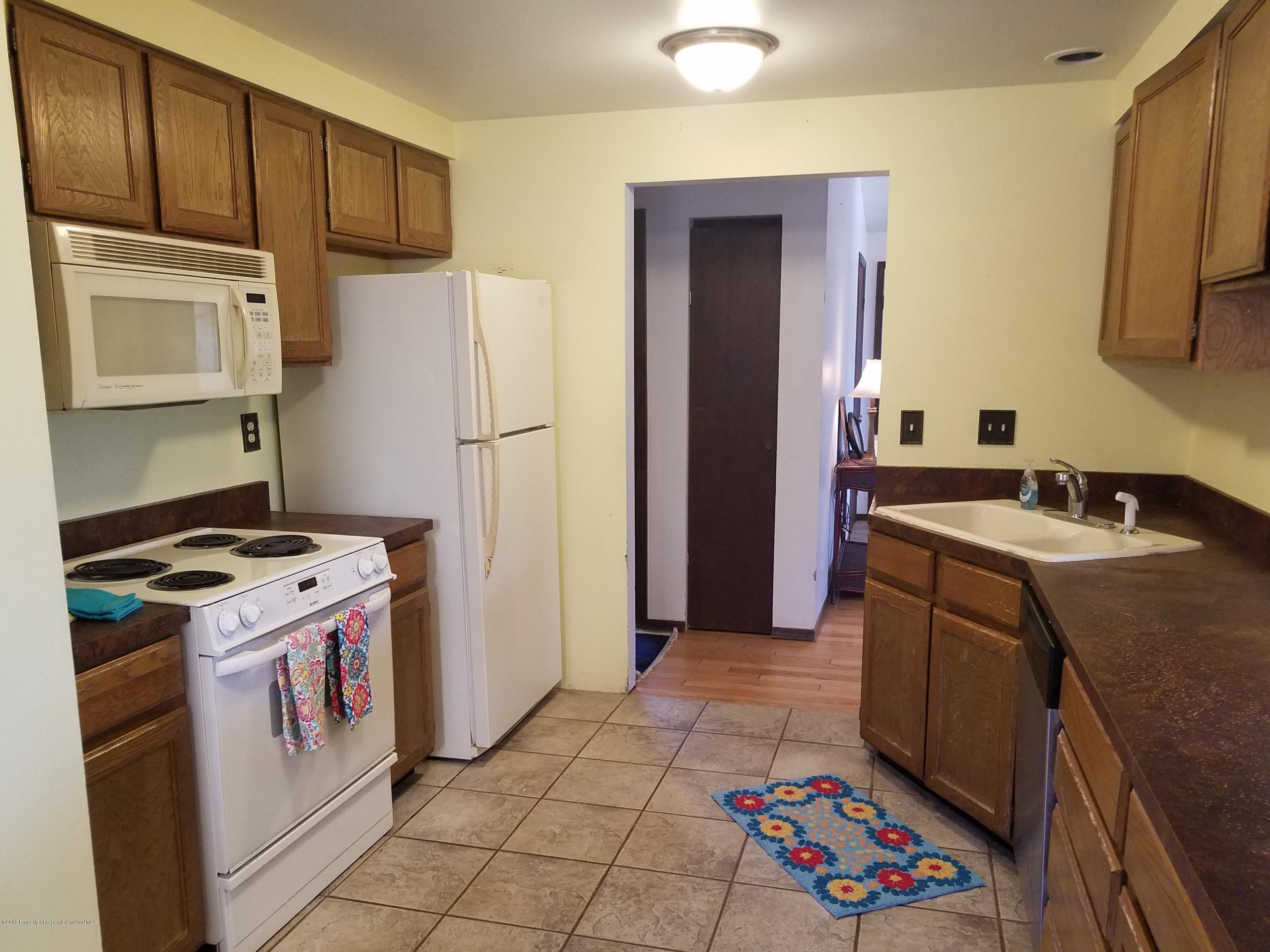 1436 Jays Avenue Rifle, CO 81650 - Photo 11 of 20 a kitchen with a sink stove and refrigerator