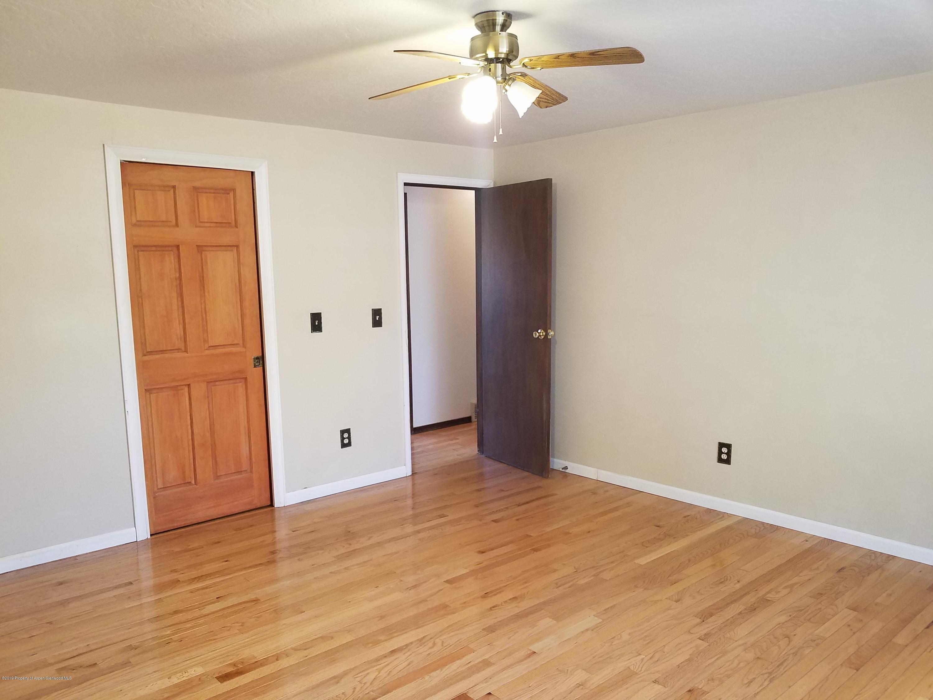 1436 Jays Avenue Rifle, CO 81650 - Photo 13 of 20 a view of an empty room with wooden floor