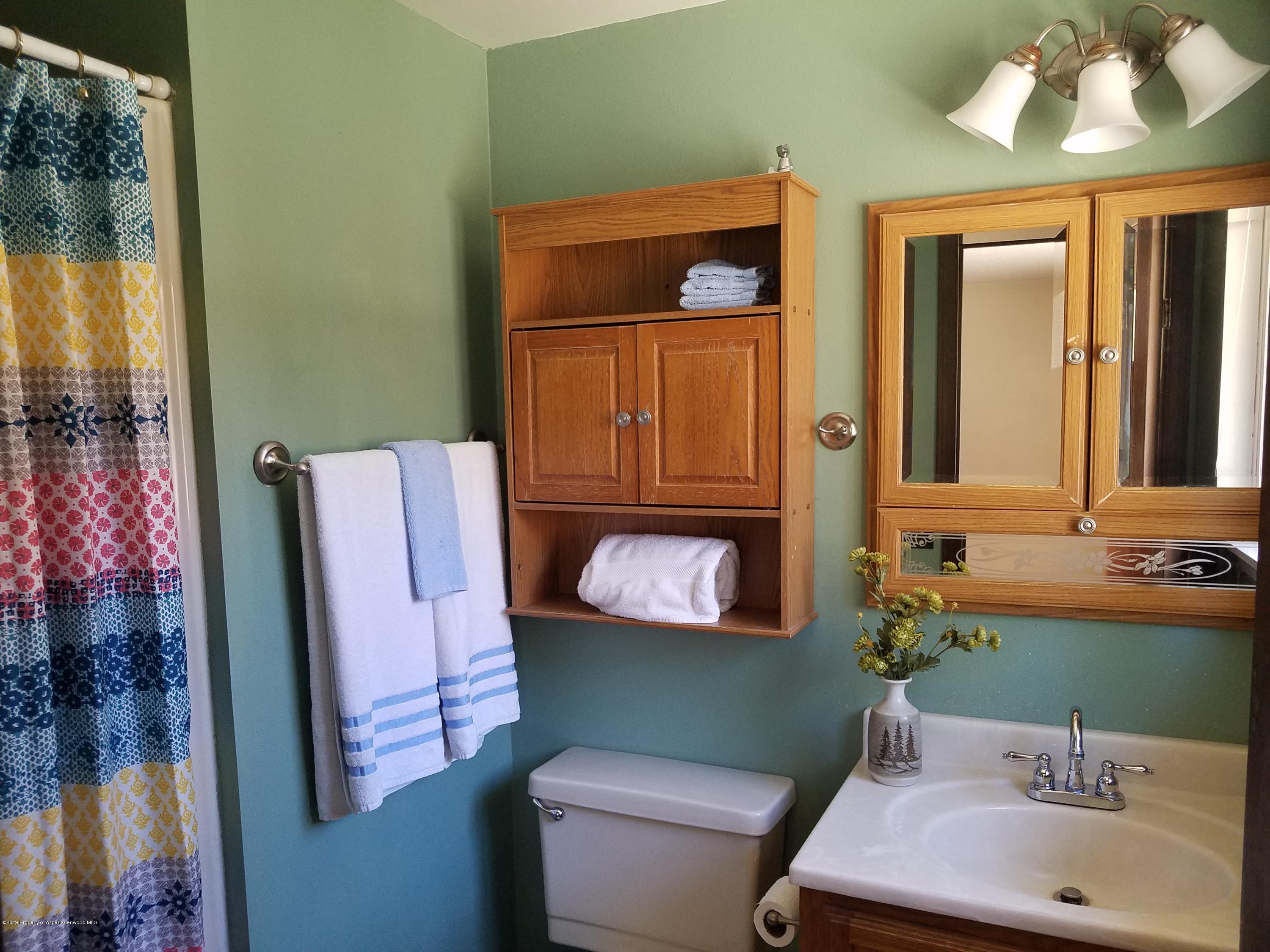1436 Jays Avenue Rifle, CO 81650 - Photo 14 of 20 a bathroom with a sink mirror and toilet