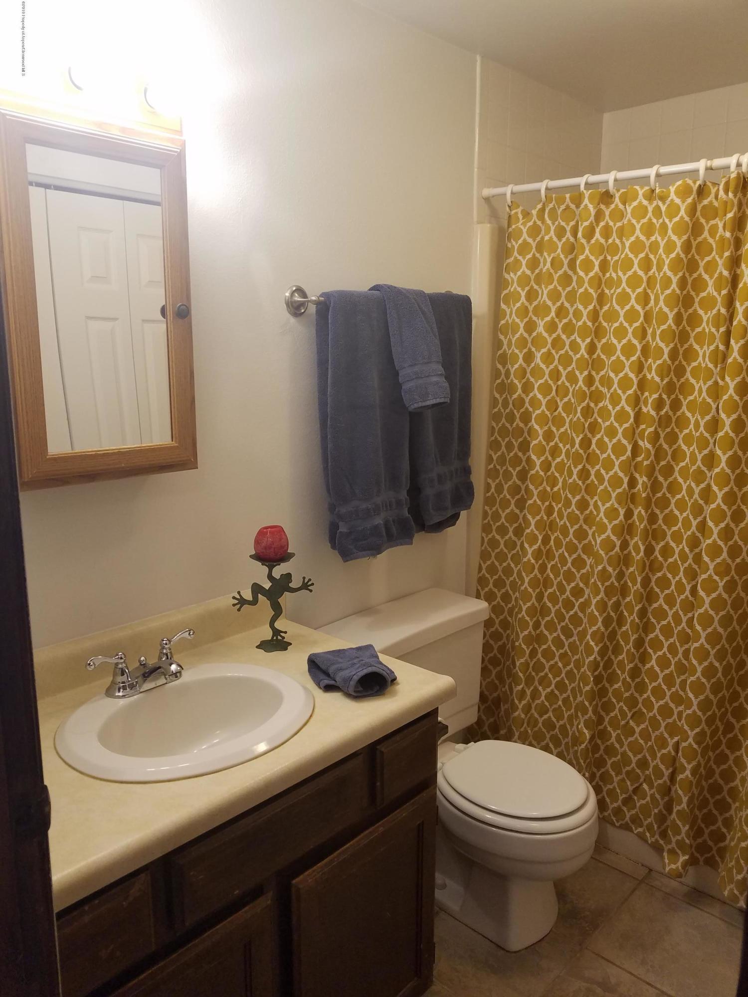 1436 Jays Avenue Rifle, CO 81650 - Photo 17 of 20 a bathroom with a sink toilet and mirror