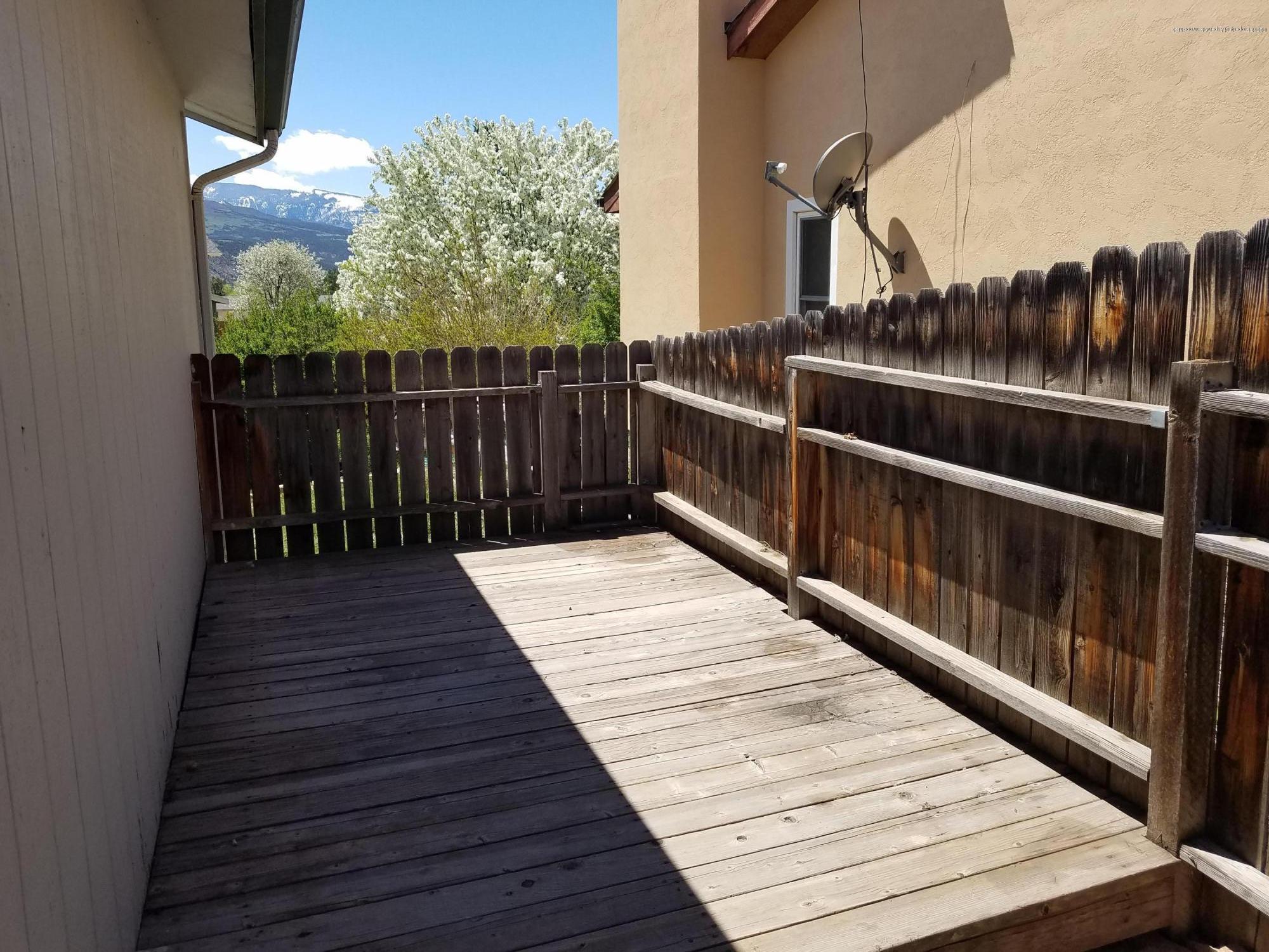 1436 Jays Avenue Rifle, CO 81650 - Photo 3 of 20 a view of balcony with wooden floor and fence