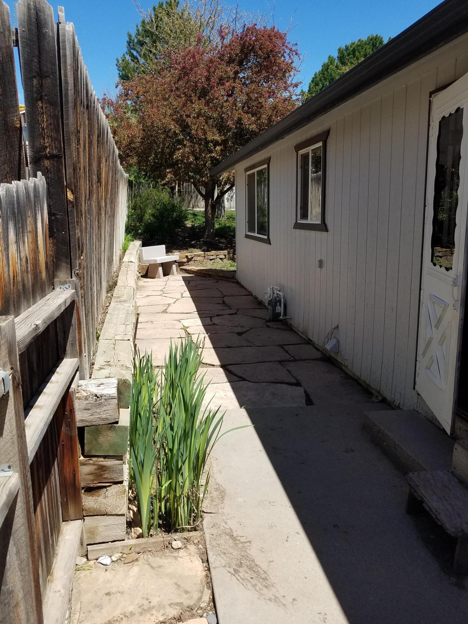 1436 Jays Avenue Rifle, CO 81650 - Photo 4 of 20 a view of backyard with barbeque grill and wooden fence