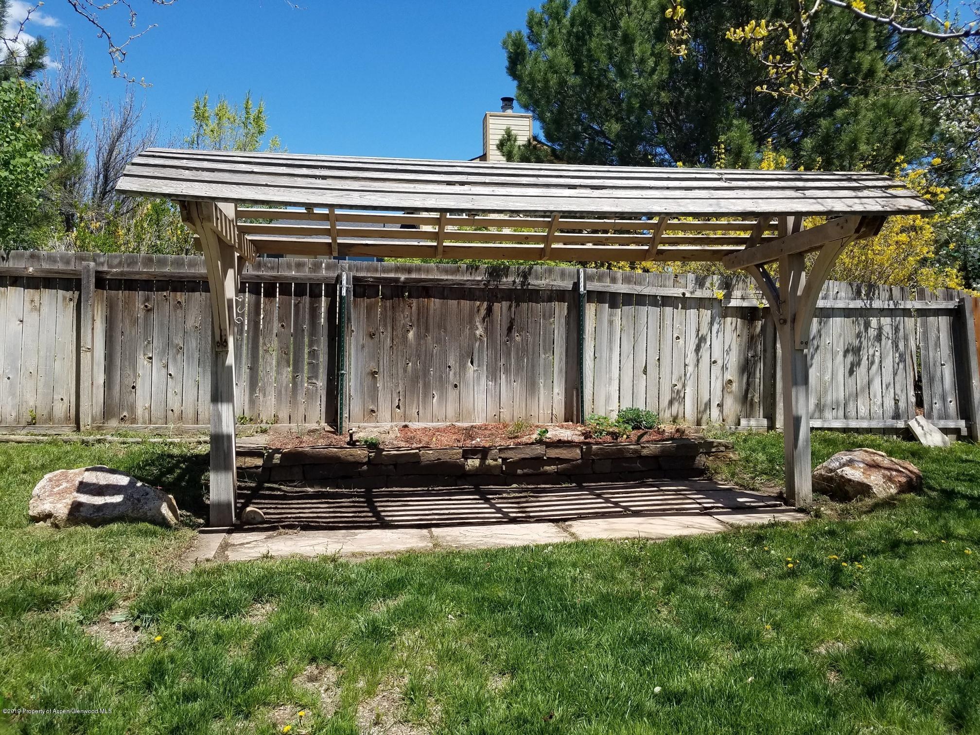 1436 Jays Avenue Rifle, CO 81650 - Photo 7 of 20 a backyard of a house with barbeque oven