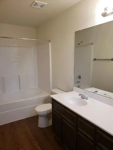 a bathroom with a sink a toilet and a bathtub