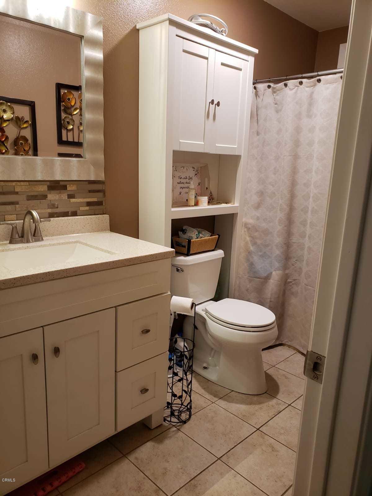2400 East Pleasant Valley Road, Unit 152 Oxnard, CA 93033 - Photo 11 of 12 a bathroom with a sink a toilet and mirror