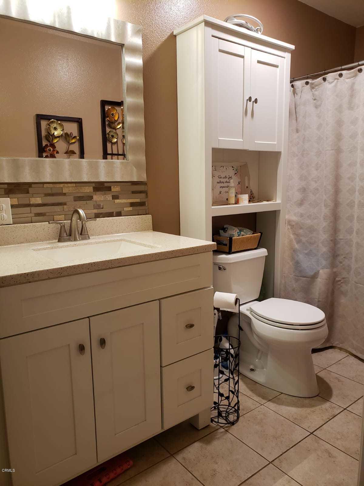 2400 East Pleasant Valley Road, Unit 152 Oxnard, CA 93033 - Photo 12 of 12 a bathroom with a sink a toilet and mirror