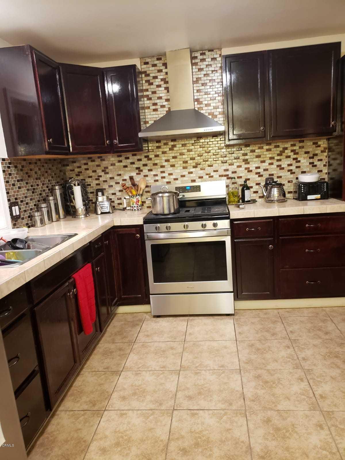 2400 East Pleasant Valley Road, Unit 152 Oxnard, CA 93033 - Photo 5 of 12 a kitchen with stainless steel appliances granite countertop a stove sink and cabinets