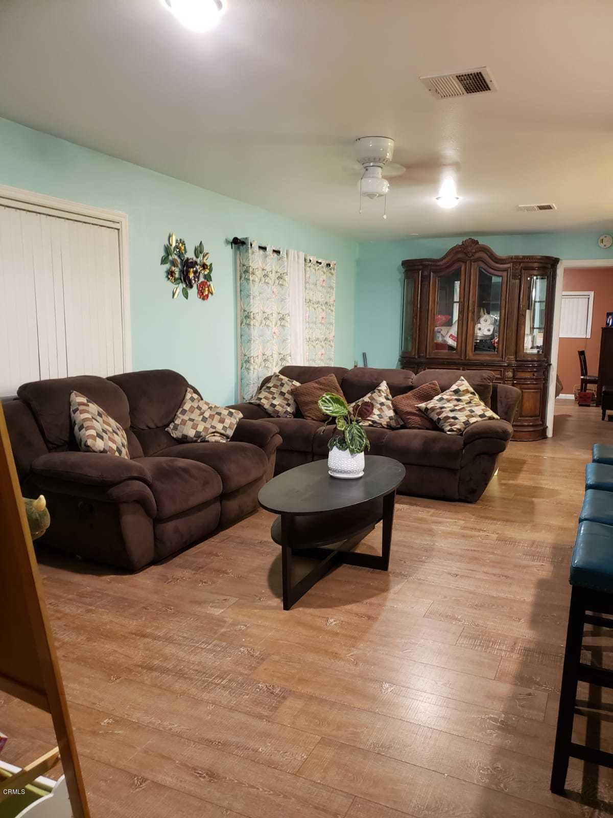 2400 East Pleasant Valley Road, Unit 152 Oxnard, CA 93033 - Photo 7 of 12 a living room with furniture and wooden floor