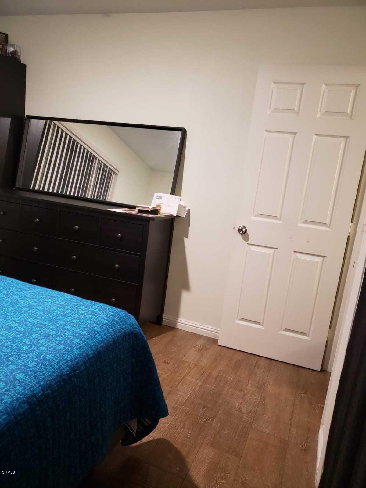 2400 East Pleasant Valley Road, Unit 152 Oxnard, CA 93033 - Photo 8 of 12 a bedroom with a bed and a window