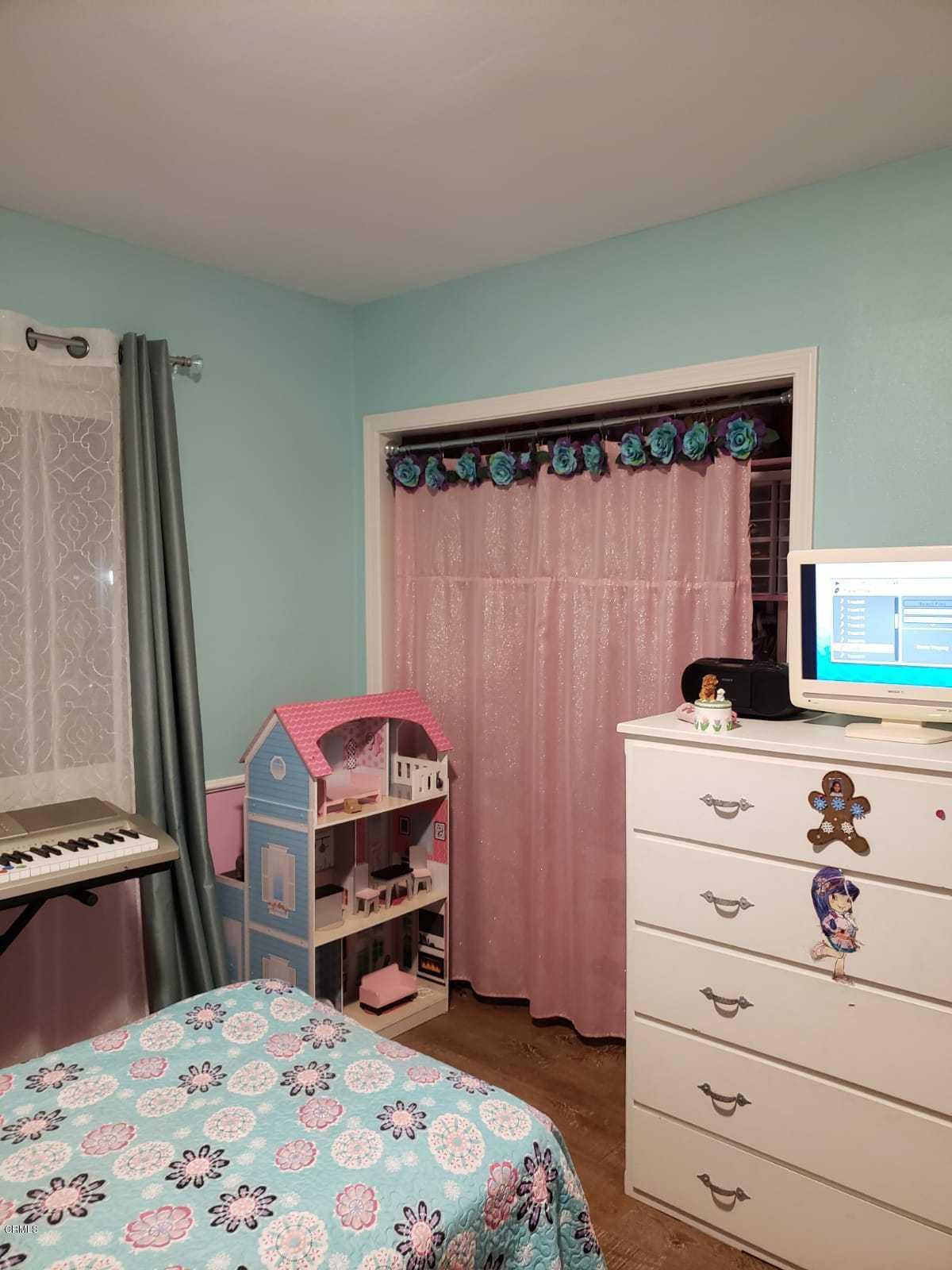 2400 East Pleasant Valley Road, Unit 152 Oxnard, CA 93033 - Photo 10 of 12 a bedroom with a bed and a dresser in it