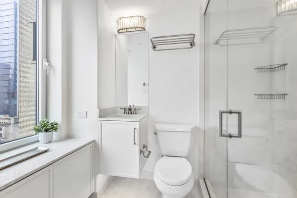 a white toilet sitting next to a bathroom sink