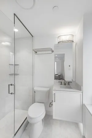 a bathroom with a toilet sink and shower