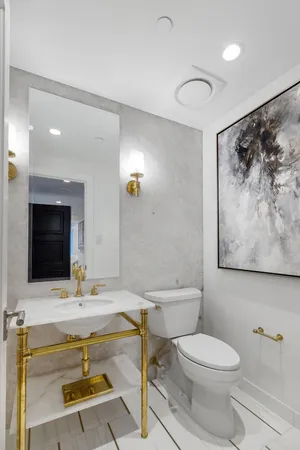 a bathroom with a sink a toilet and mirror