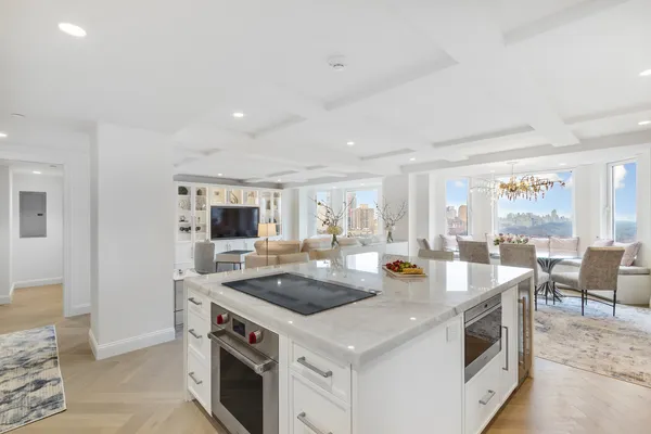 a kitchen that has a sink and a stove in it
