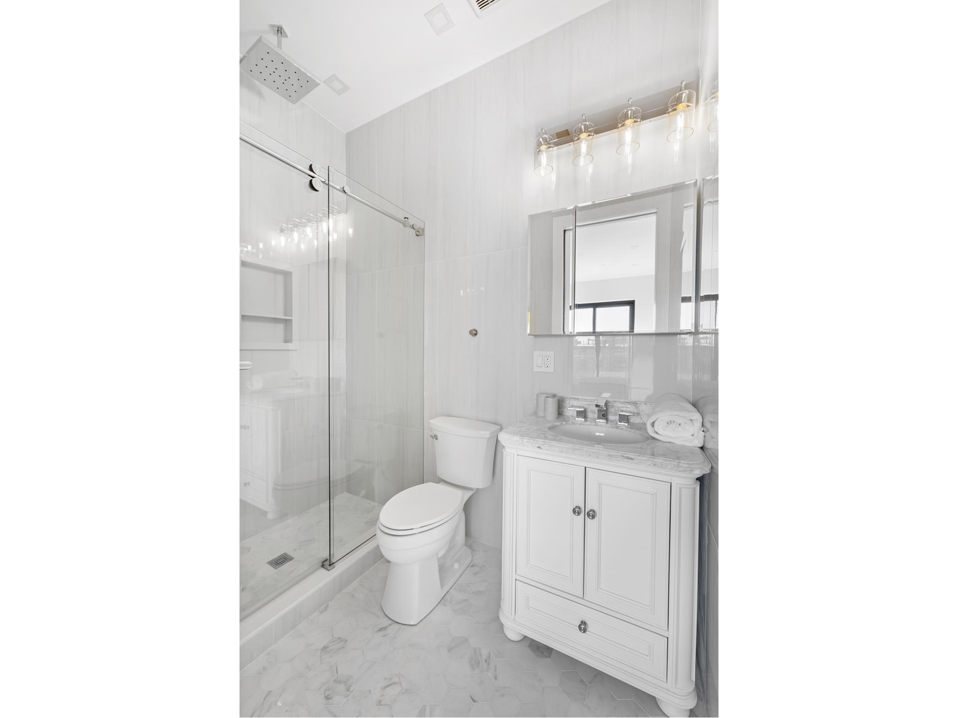 112 Luquer Street, Unit 2 Brooklyn, NY 11231 - Photo 7 of 11 a bathroom with a toilet a sink and a mirror