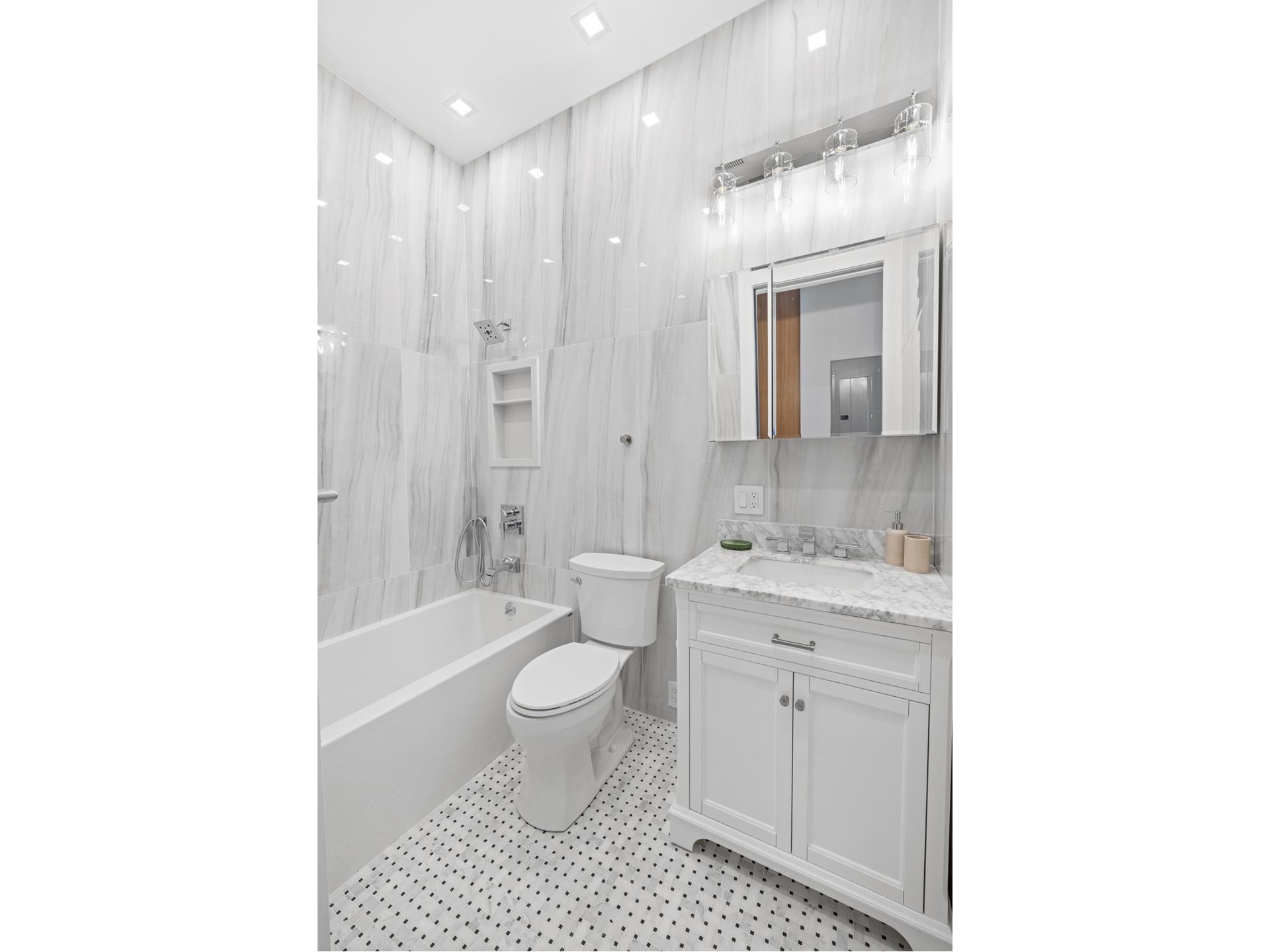 112 Luquer Street, Unit 2 Brooklyn, NY 11231 - Photo 9 of 11 a bathroom with a granite countertop sink a toilet and shower